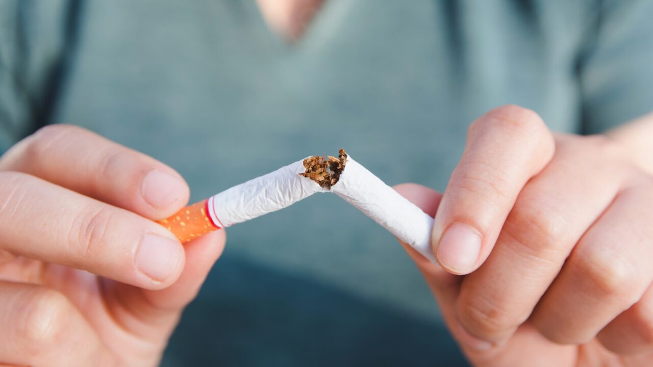 Stop cigarette, woman hands breaking the cigarette with clipping path